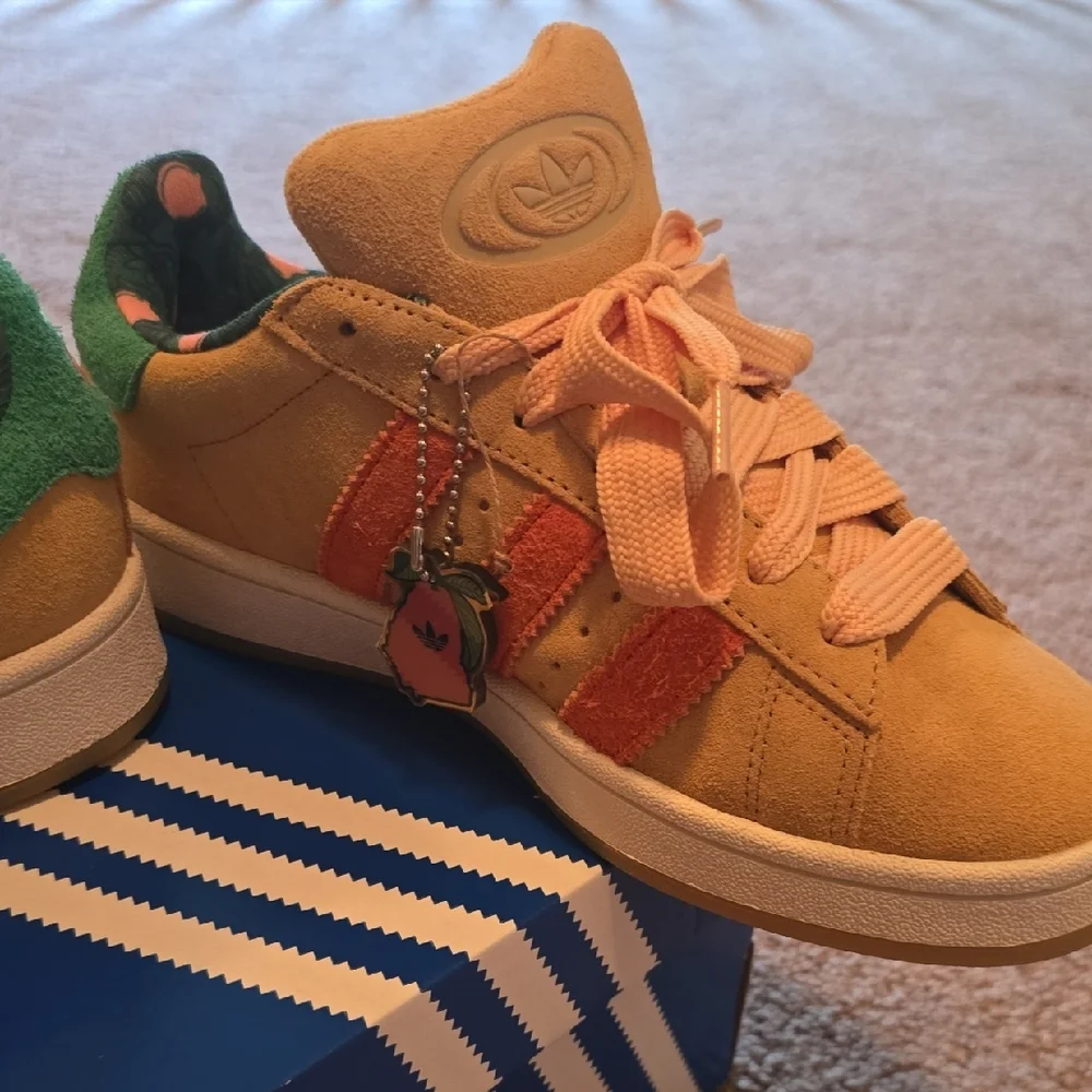 adidas Suede Low-Top Sneakers in Peach with Orange Stripes